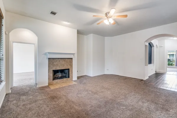 wooden floor chandelier fan and fire place
