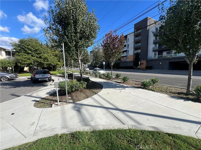 a view of a park with bench and trees