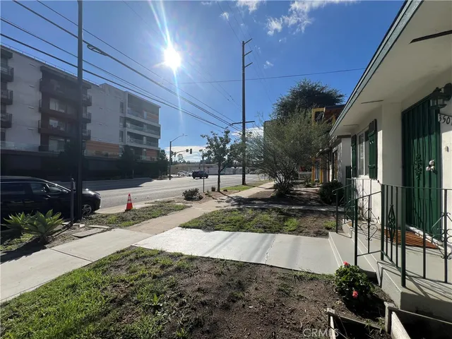 a view of a building with a pathway and a yard