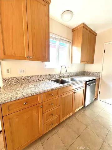 a kitchen with stainless steel appliances granite countertop a sink and a white cabinets