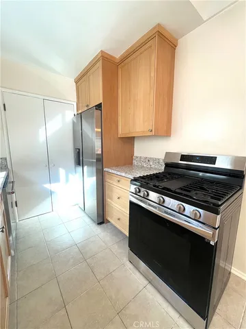 a kitchen with a stove a refrigerator and a microwave