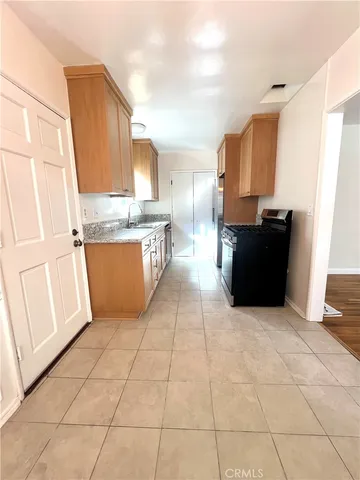 a kitchen with stainless steel appliances granite countertop a refrigerator a stove top oven and a granite counter tops