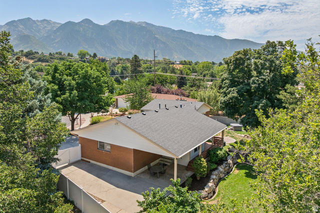 2370 Quail Run Circle East Sandy, UT 84093 - Photo 48 of 54 Brick exterior with a covered carport, private fenced yard, and tiered landscaping