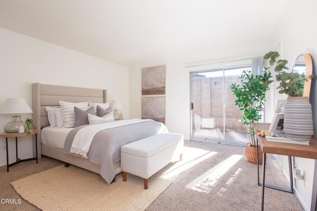 17516 Via Calma, Unit 39 Tustin, CA 92780 - Photo 11 of 29 a spacious bedroom with a bed a couch and potted plant