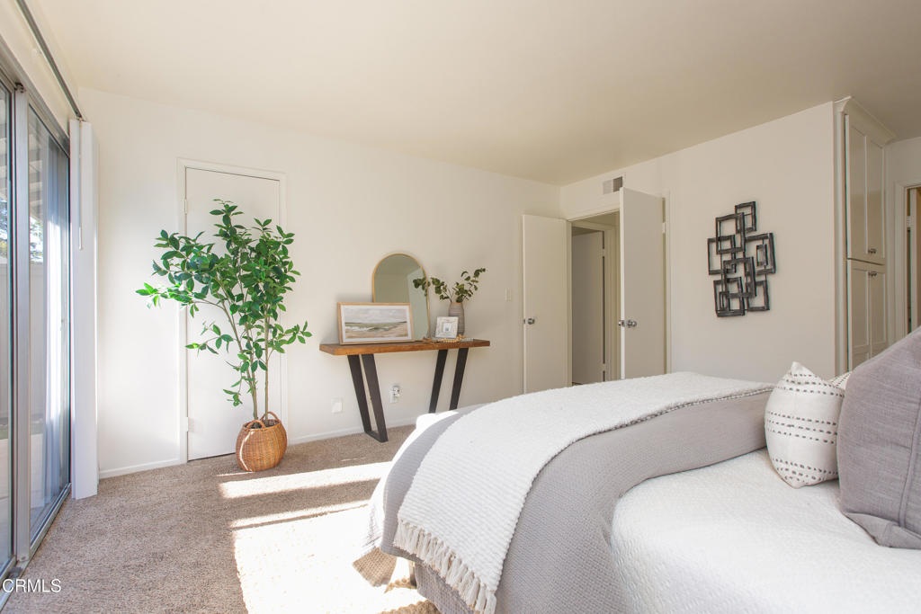 17516 Via Calma, Unit 39 Tustin, CA 92780 - Photo 14 of 29 a bedroom with a bed and a potted plant