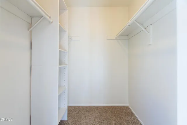 a bedroom with a bed and a potted plant