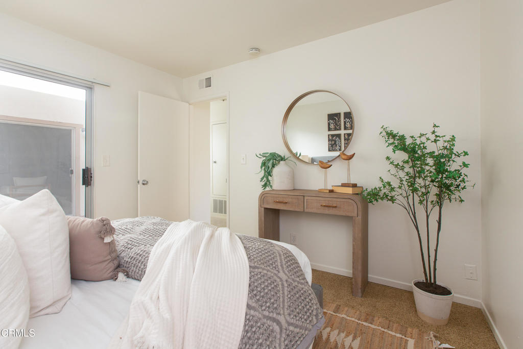 17516 Via Calma, Unit 39 Tustin, CA 92780 - Photo 21 of 29 a bedroom with a bed and a potted plant