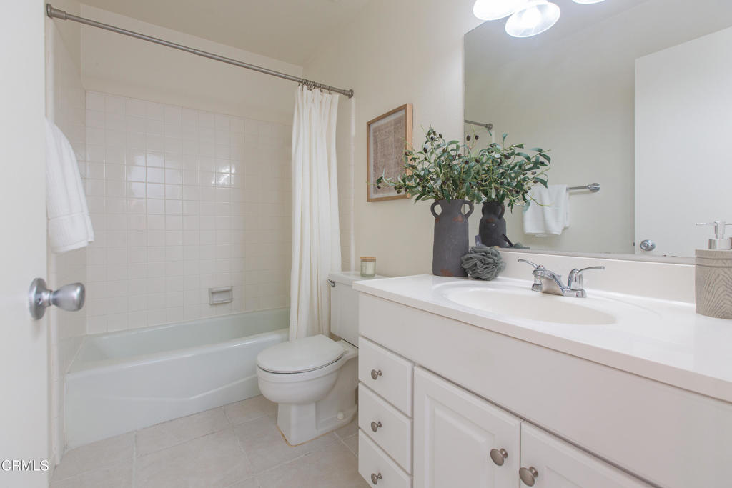 17516 Via Calma, Unit 39 Tustin, CA 92780 - Photo 23 of 29 a bathroom with a sink a toilet and a large mirror
