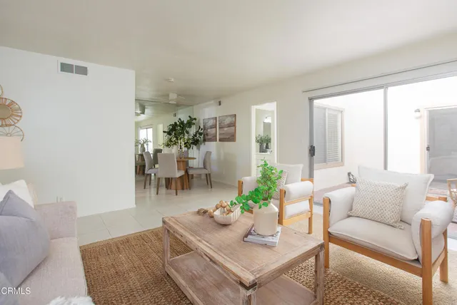 a dining room with furniture and a potted plant