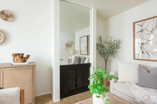 a dining room with furniture and a potted plant