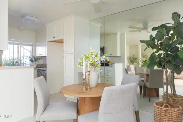 a kitchen with white cabinets and appliances