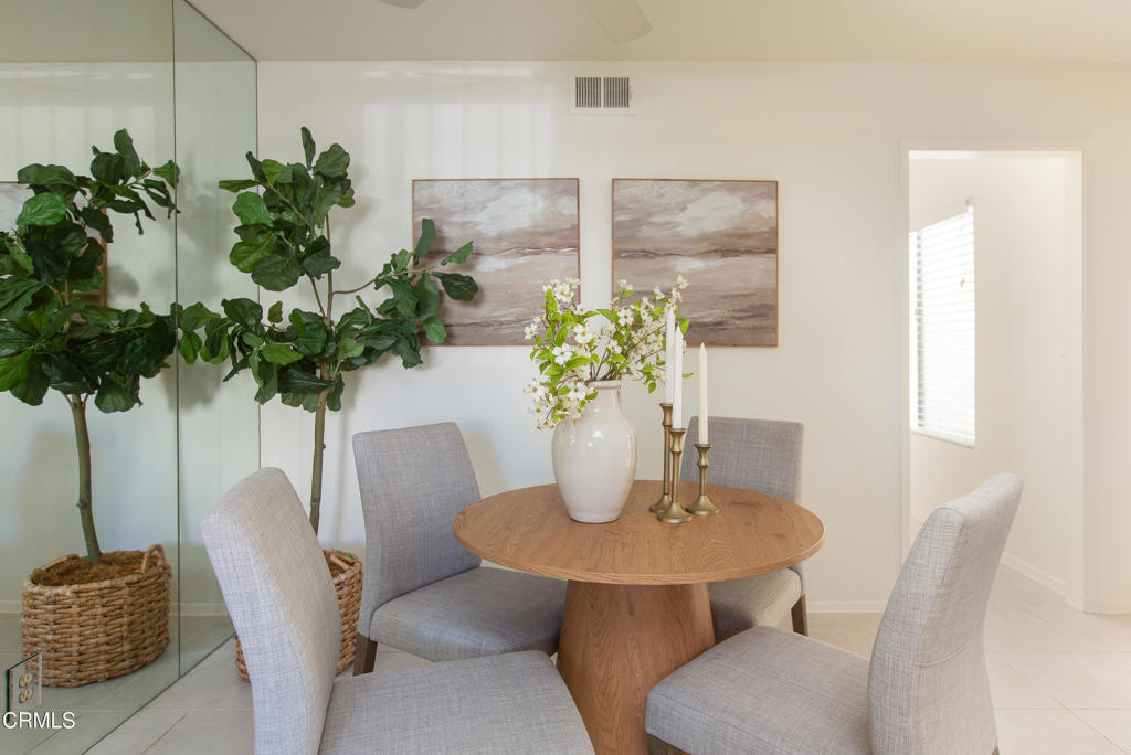 17516 Via Calma, Unit 39 Tustin, CA 92780 - Photo 7 of 29 a dining room with furniture and a potted plant