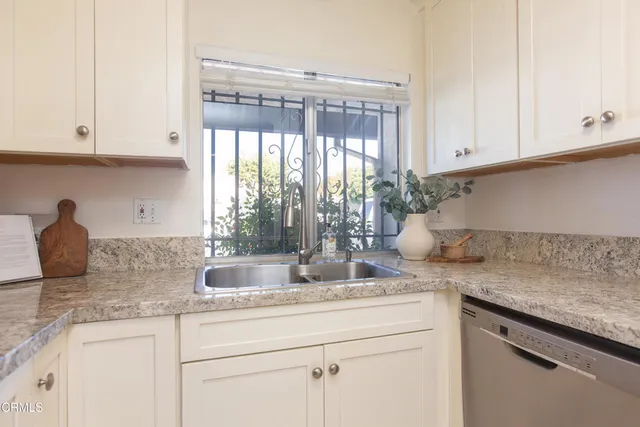 a spacious bedroom with a bed a couch and potted plant