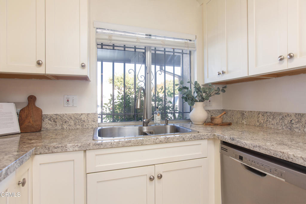 17516 Via Calma, Unit 39 Tustin, CA 92780 - Photo 9 of 29 a kitchen with granite countertop stainless steel appliances white cabinets and a sink