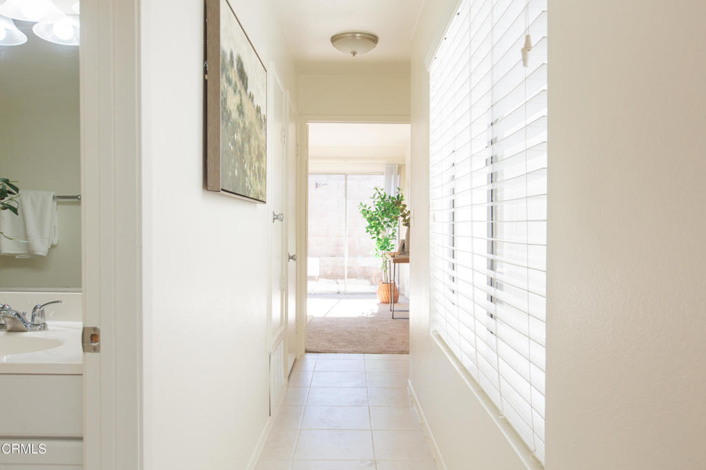 17516 Via Calma, Unit 39 Tustin, CA 92780 - Photo 10 of 29 a view of a hallway with wooden floor and a bathroom