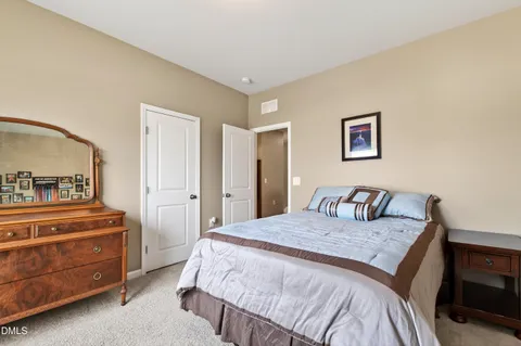 a bedroom with a bed and a dresser