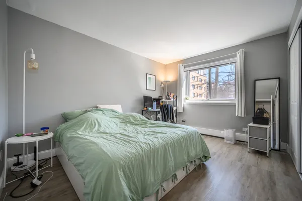 a bed sitting in a bedroom next to a window