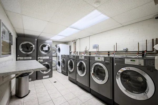 a utility room with dryer washer and other items