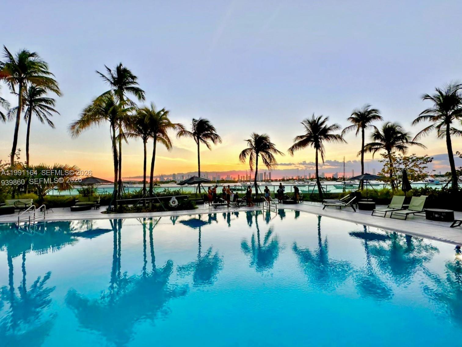 1500 Bay Road, Unit 854S Miami Beach, FL 33139 - Photo 8 of 20 a view of swimming pool with outdoor seating and lake view