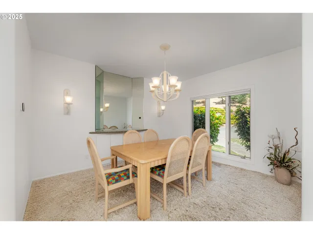 a view of a dining room with furniture and a chandelier