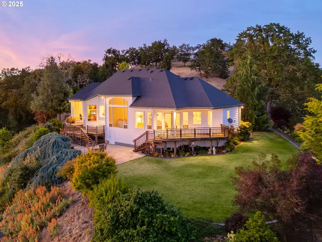 a view of a house with garden and sitting area