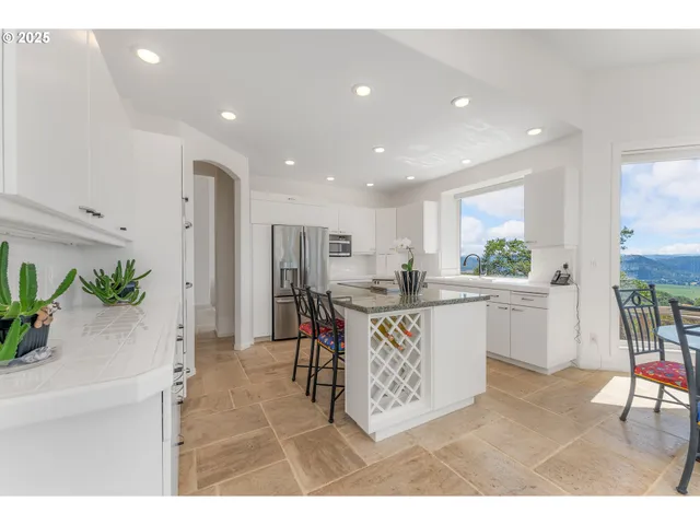 a kitchen with a table and chairs
