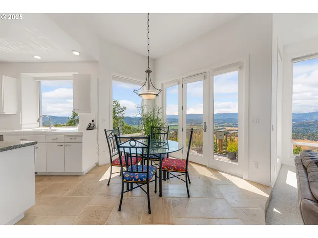 a dining room with furniture a chandelier and wooden floor