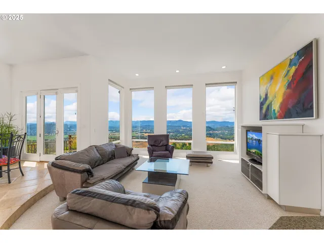 a living room with fireplace furniture and a large window