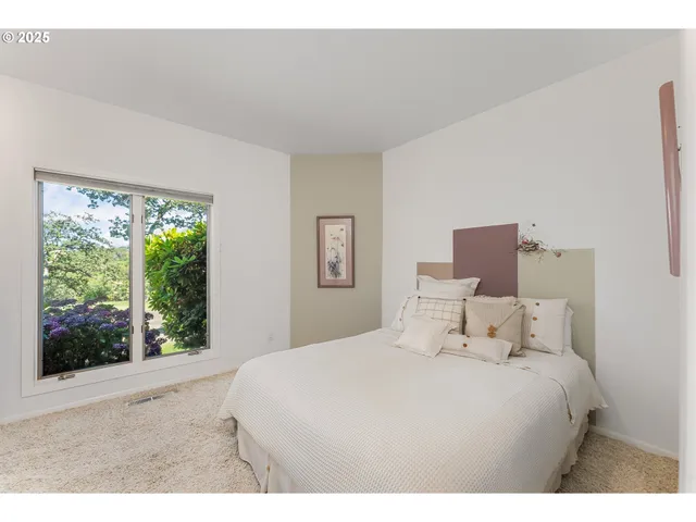 a bedroom with a large bed and a large window