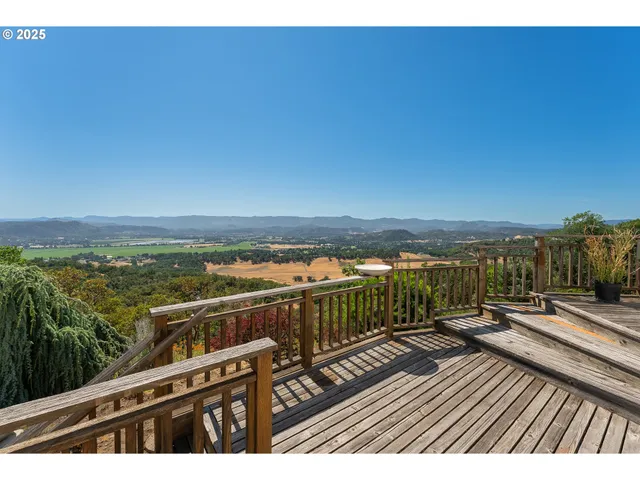 a view of a balcony with wooden floor and city view