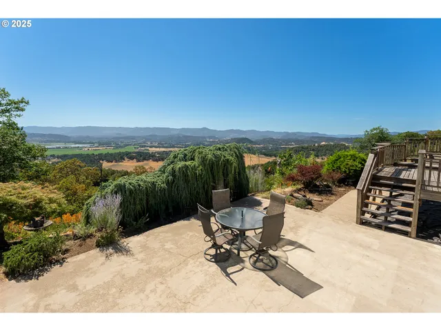 a view of a ocean with a table and chairs