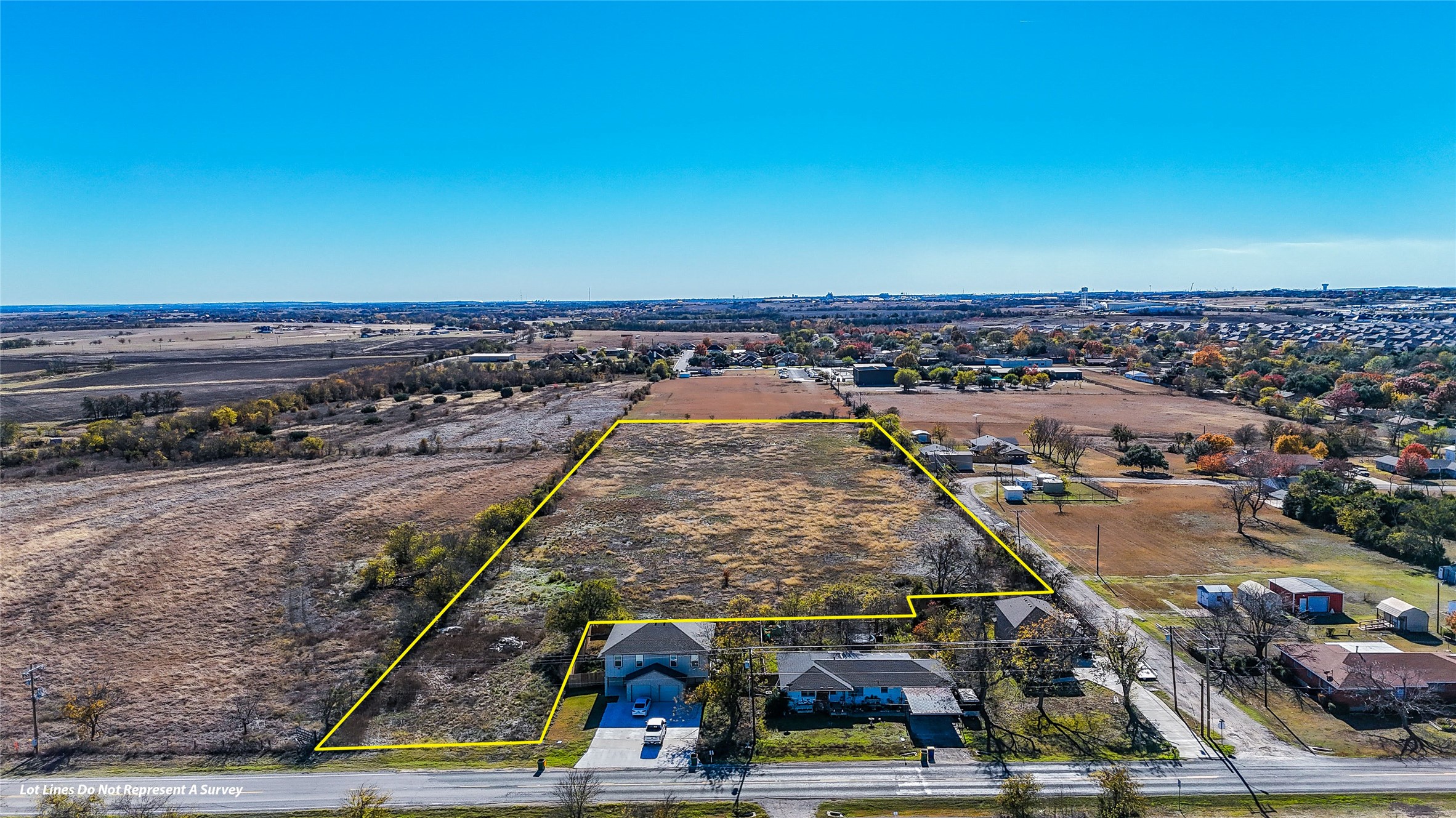 Aerial view of property and surrounding area with property parcel outlined