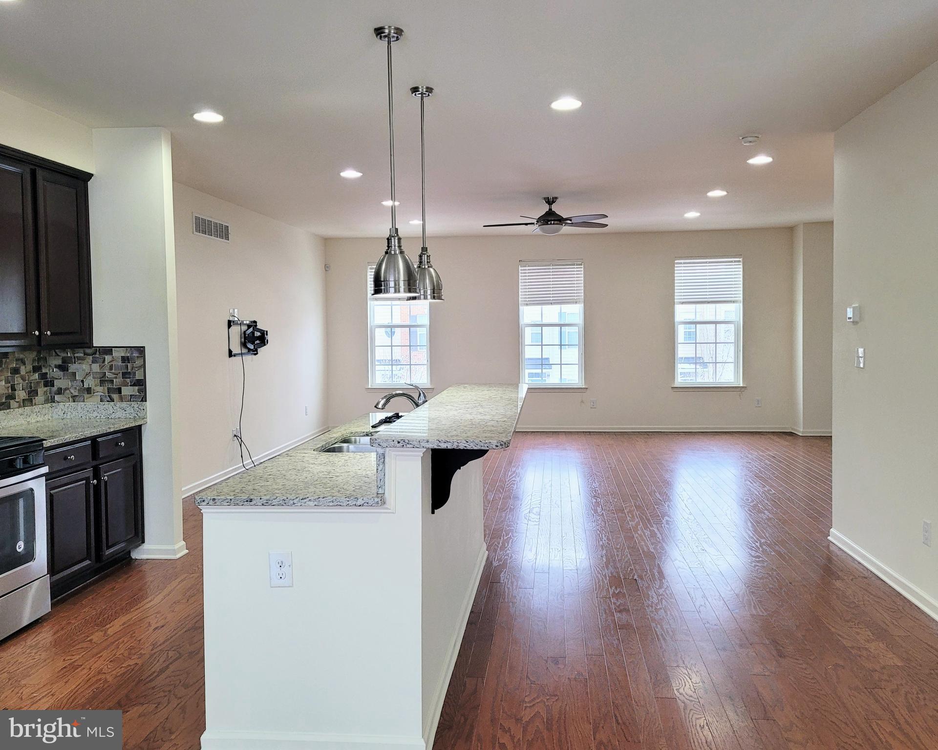 628 Rigel Way Bear, DE 19701 - Photo 6 of 20 a view of living room kitchen with a stove and wooden floor