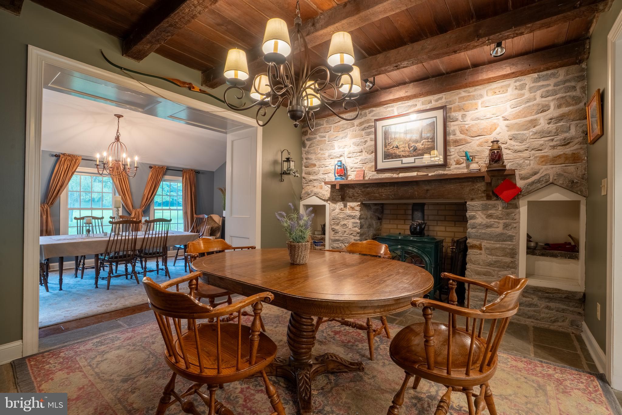 1627 East Saw Mill Road Quakertown, PA 18951 - Photo 24 of 61 a dining room with furniture a floor to ceiling window and a fireplace