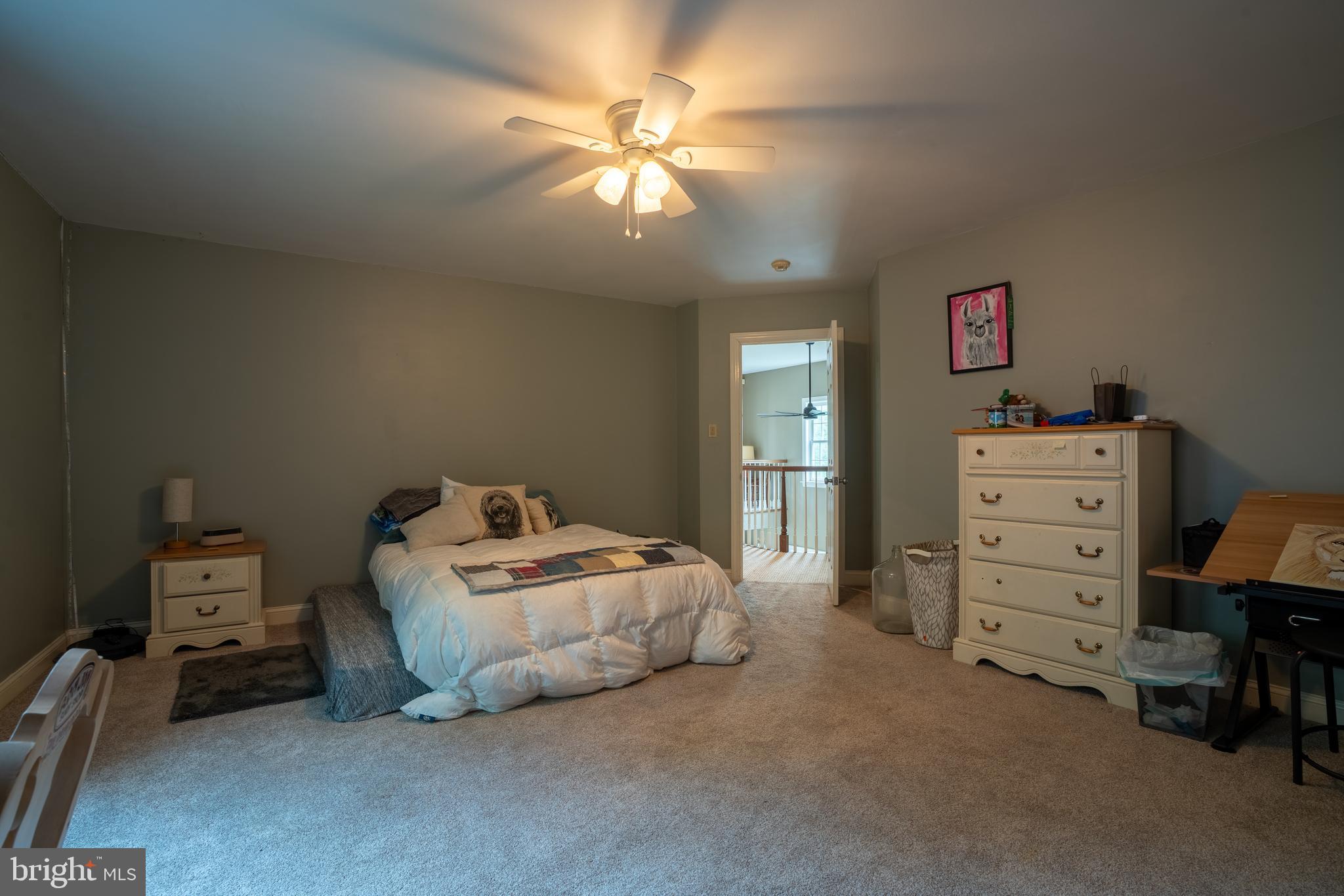 1627 East Saw Mill Road Quakertown, PA 18951 - Photo 44 of 61 a bedroom with a bed and a chandelier