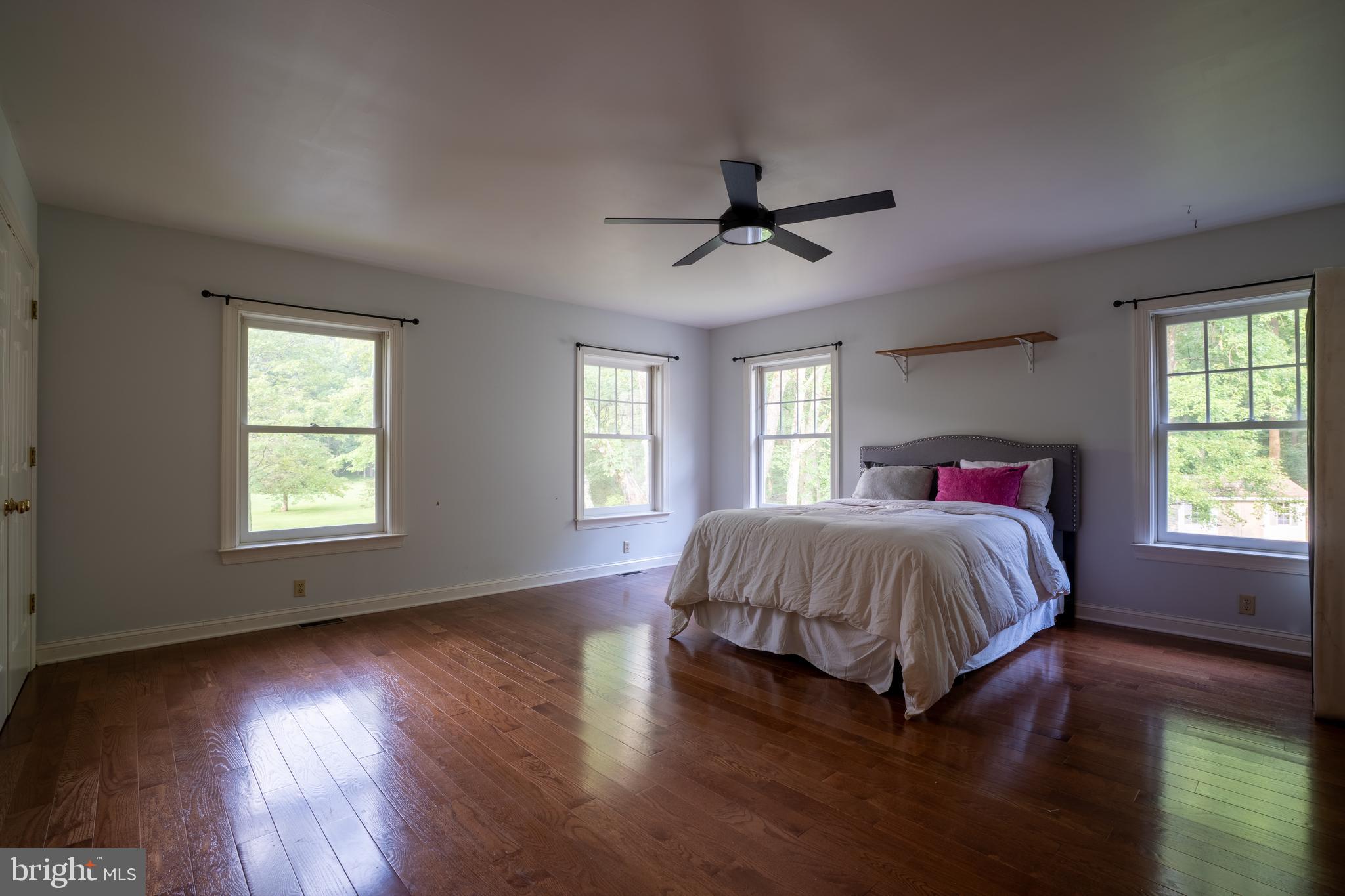 1627 East Saw Mill Road Quakertown, PA 18951 - Photo 54 of 61 a spacious bedroom with a bed and wooden floor