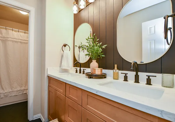 a bathroom with a double vanity sink and a mirror