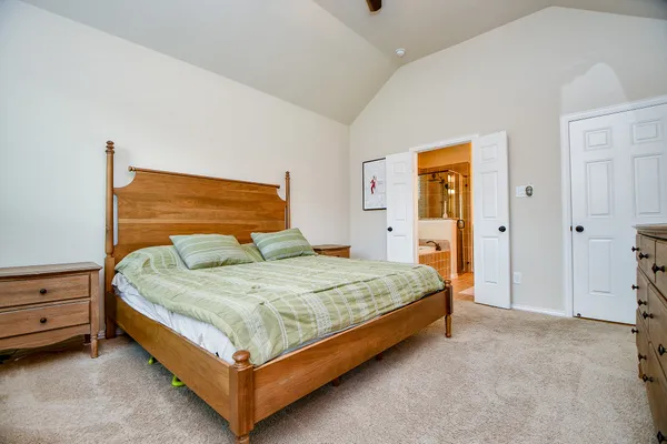 a bed sitting in a bedroom and closet
