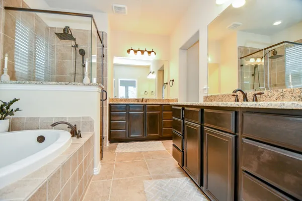 a spacious bathroom with a bathtub sink and mirror