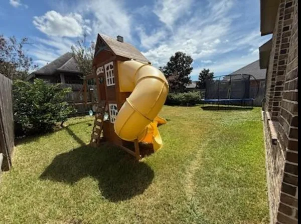 a backyard of a house with table and chairs