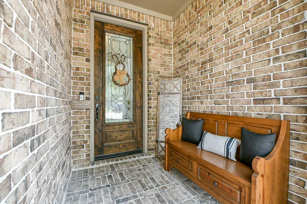 a view of a wooden bench sitting in front of a door