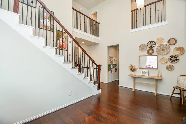 a view of entryway with wooden floor and stairs