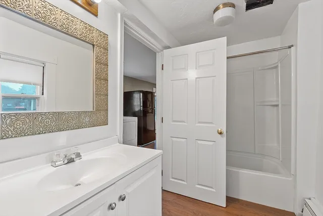 a bathroom with a sink a mirror and a shower
