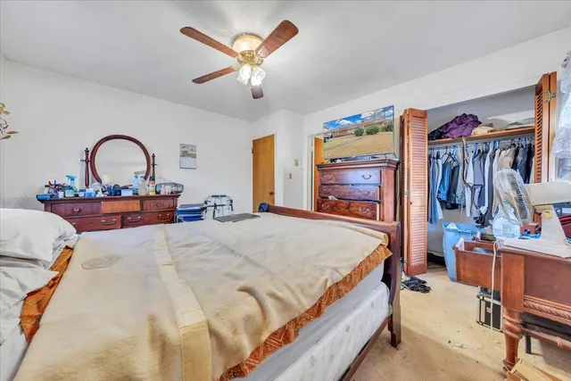a bedroom with bed and a chandelier