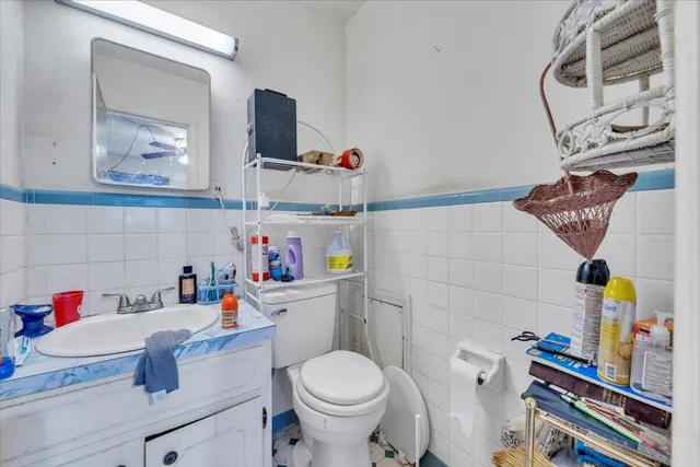 a bathroom with a toilet sink and mirror