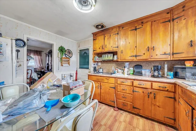 a kitchen with stainless steel appliances a sink dishwasher and cabinets with wooden floor