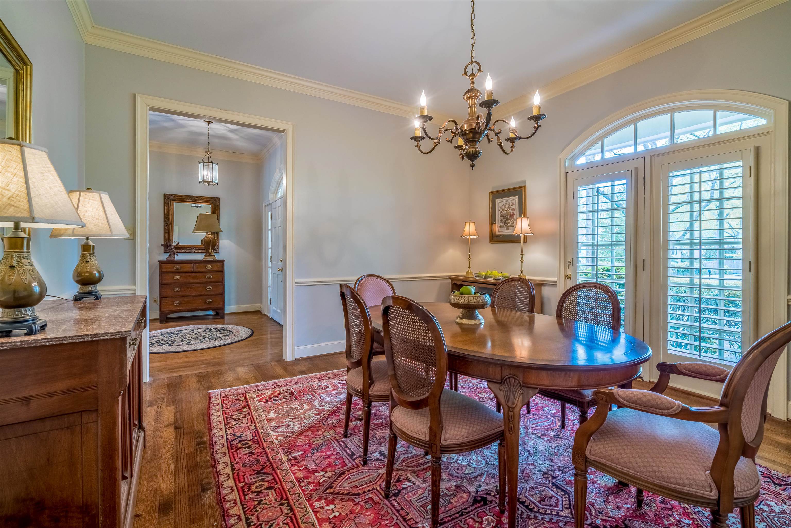 4437 Normandy Road Memphis, TN 38117 - Photo 8 of 25 a view of a dining room with furniture a chandelier and wooden floor