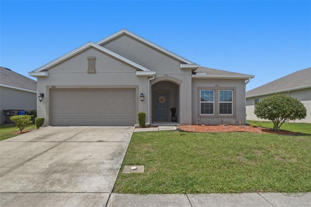 3933 Wind Dancer Circle St. Cloud, FL 34772 - Photo 1 of 35 a front view of a house with a yard