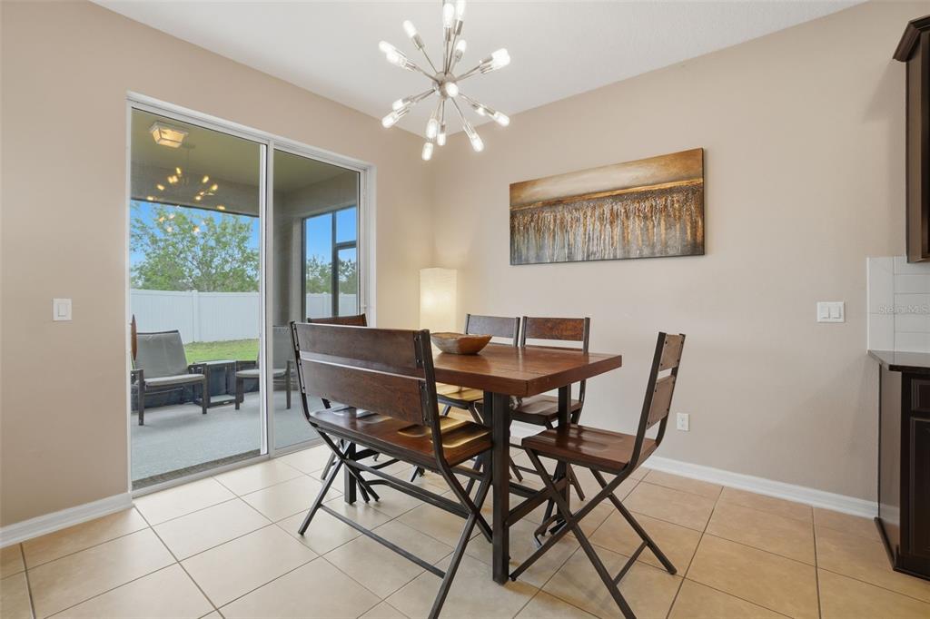 3933 Wind Dancer Circle St. Cloud, FL 34772 - Photo 14 of 35 a view of a dining room with furniture and a chandelier