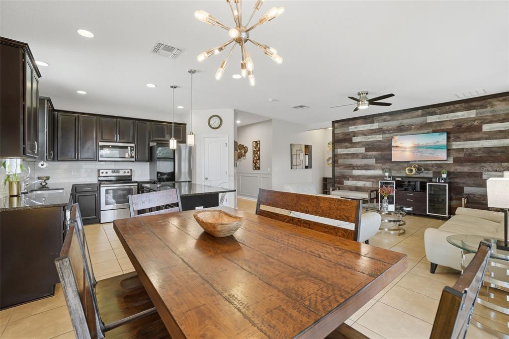 3933 Wind Dancer Circle St. Cloud, FL 34772 - Photo 15 of 35 a living room with lots of furniture and kitchen view